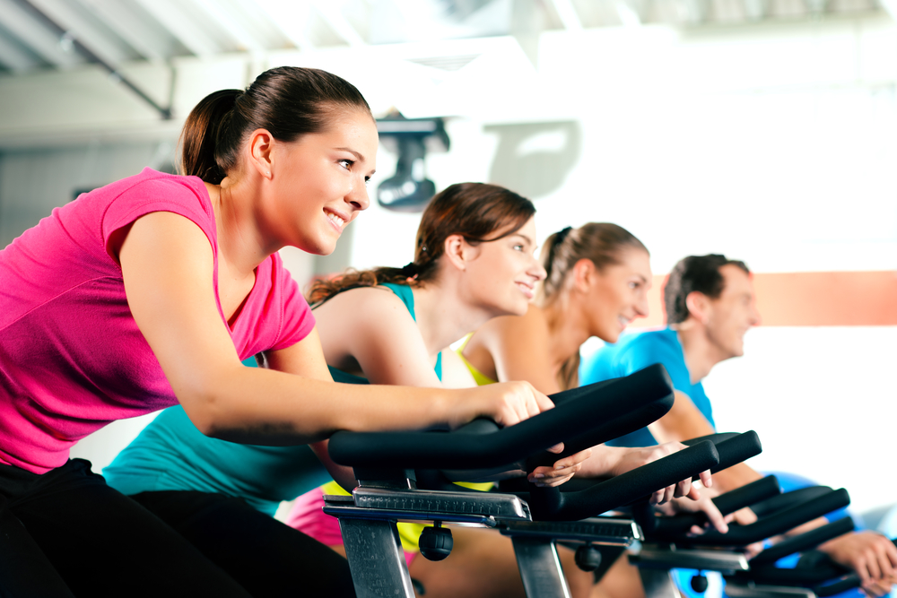 group of people using exercise bikes